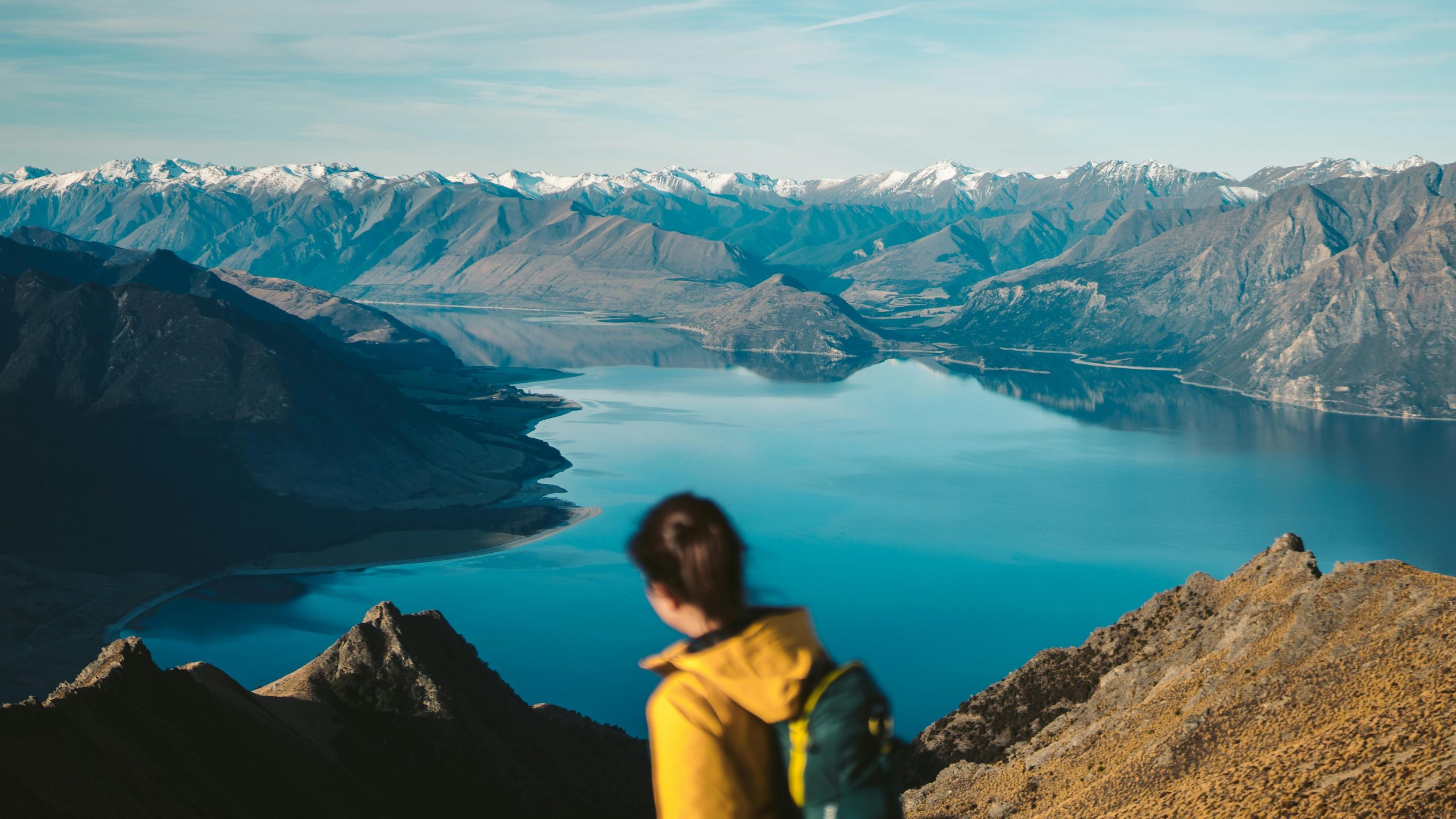 Hiker using smartwatch with altimeter feature overlooking mountains
