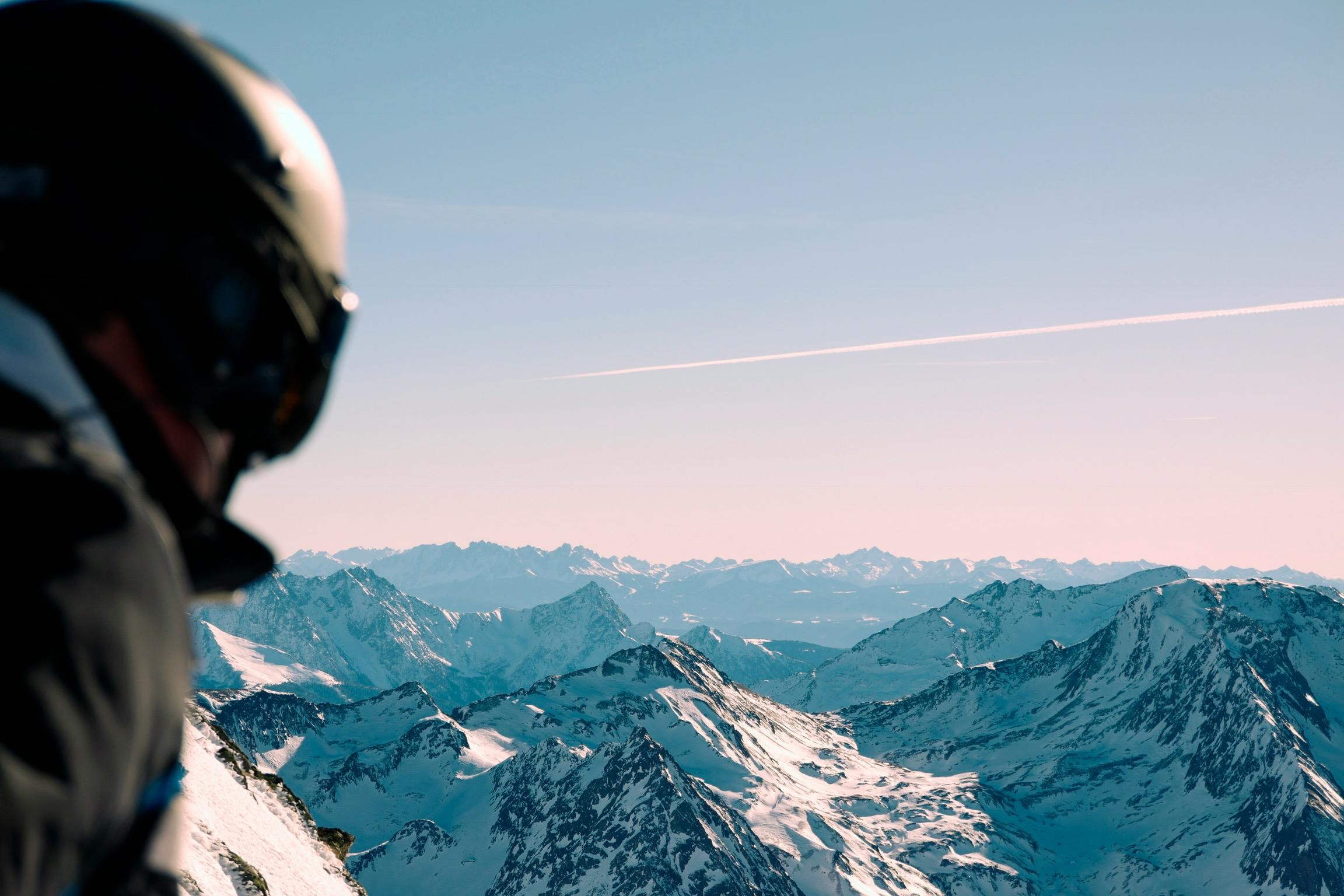 Climber consulting their watch altimeter on a snowy peak