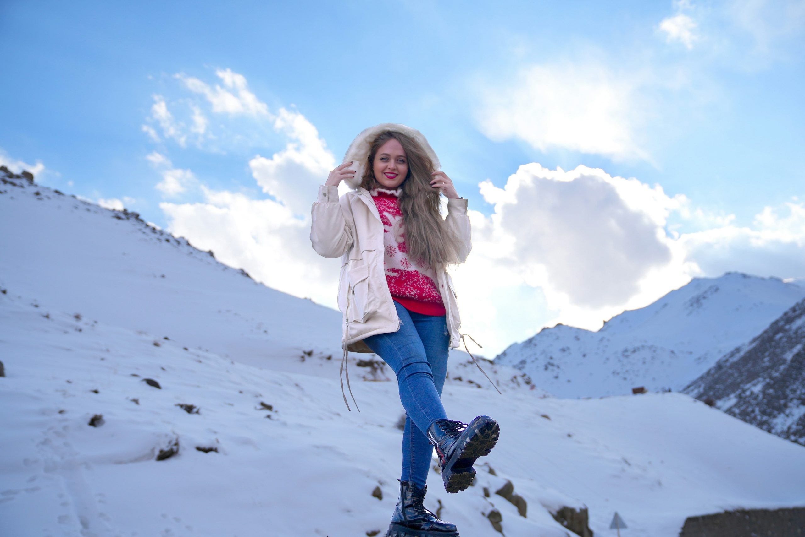 Sarah D. posing with her Garmin Fenix watch altimeter on a snowy peak