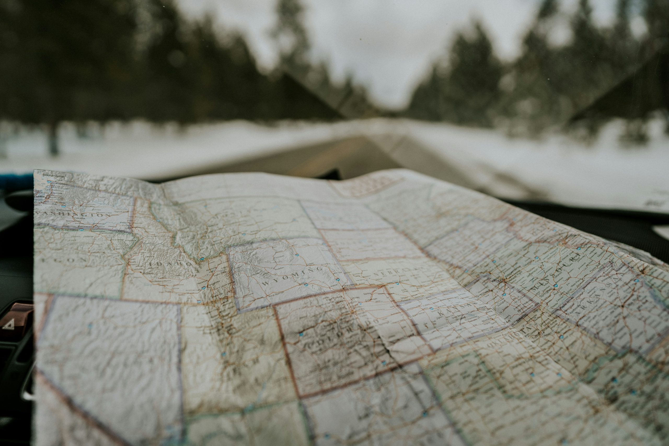 A hiker looking at a map lost in the woods