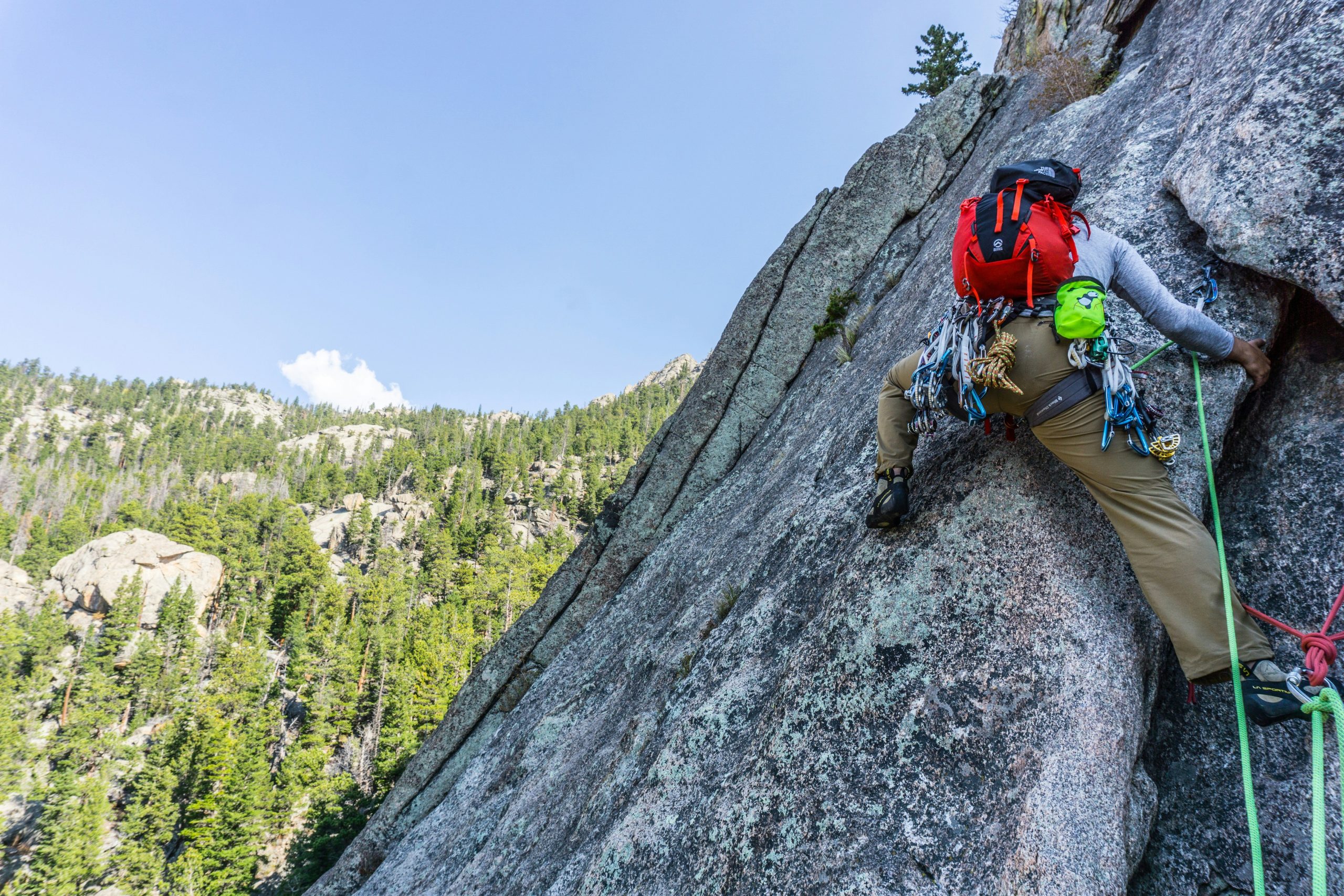 Hiker using a smartwatch to track altitude on a steep trail