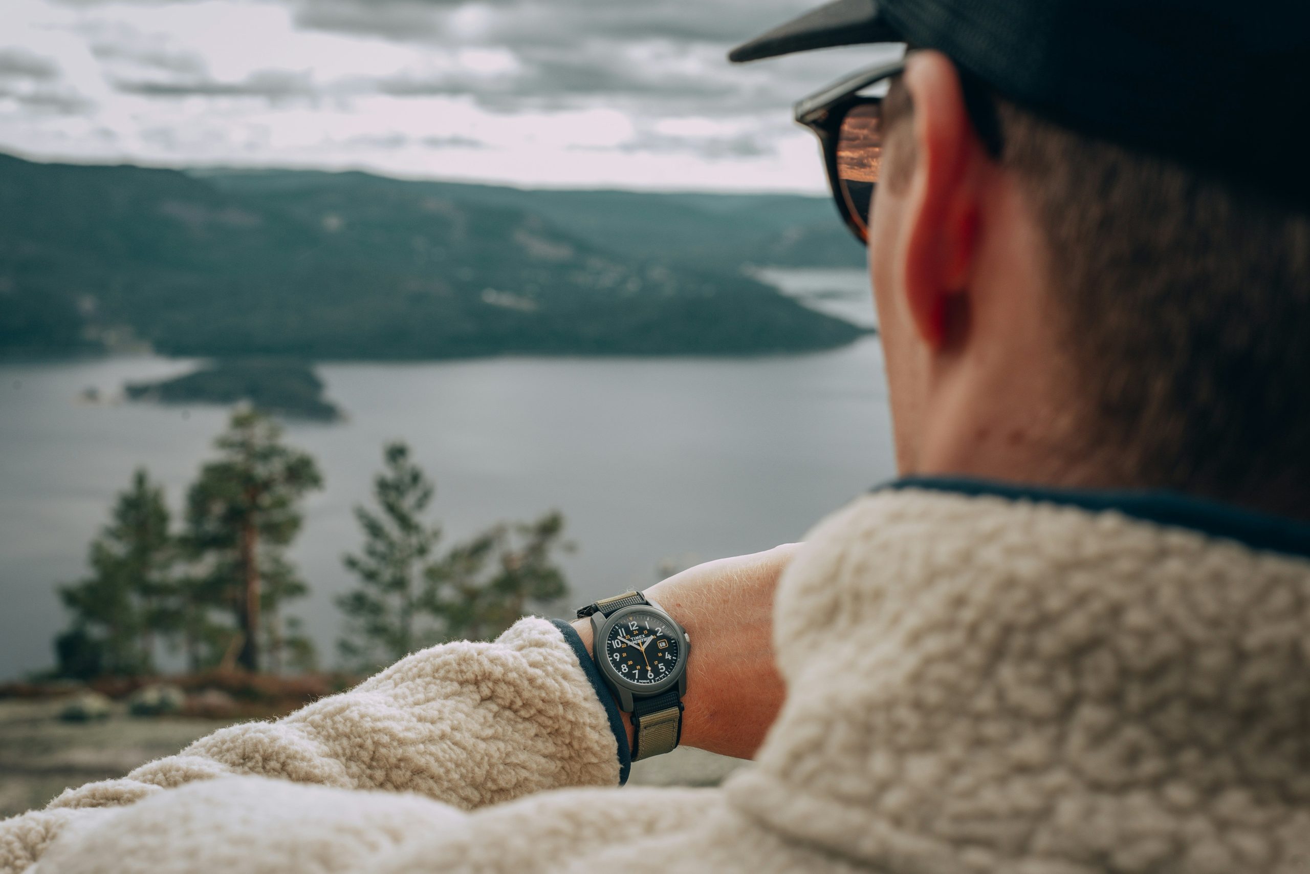 Professional climber checking altimeter reading on his smartwatch