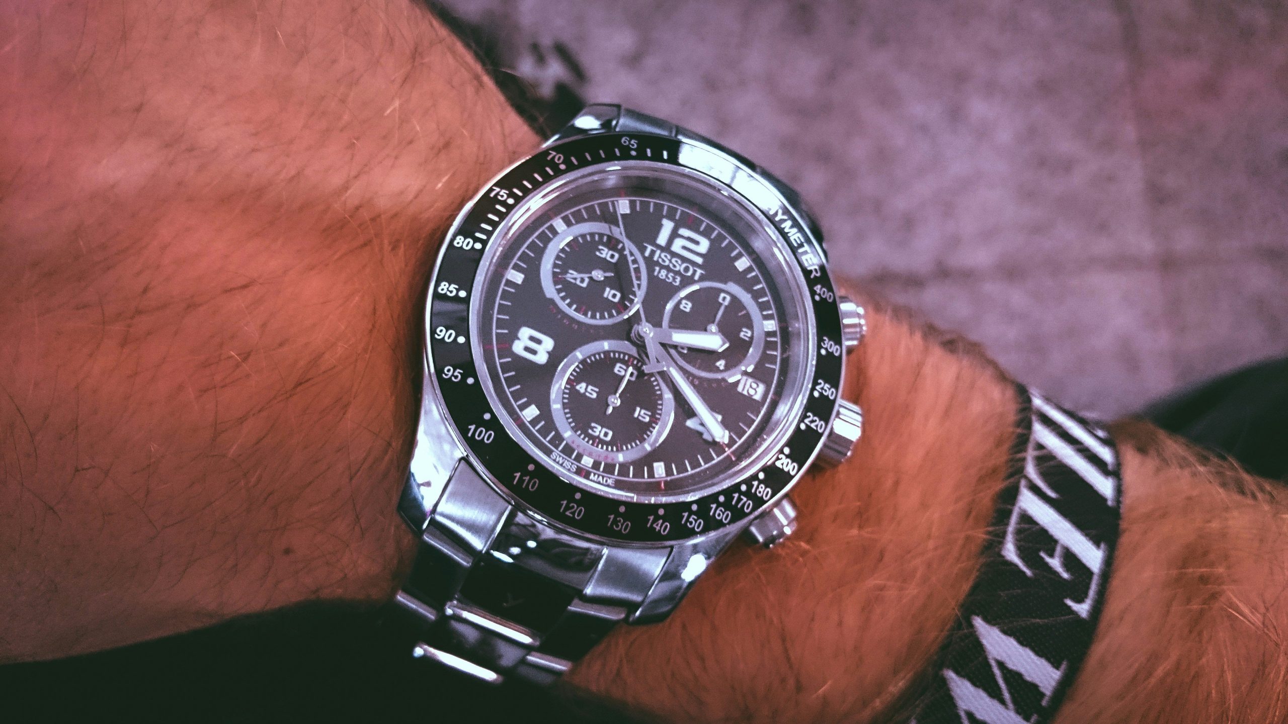 Trekker celebrating reaching summit while wearing a rugged trekking watch.
