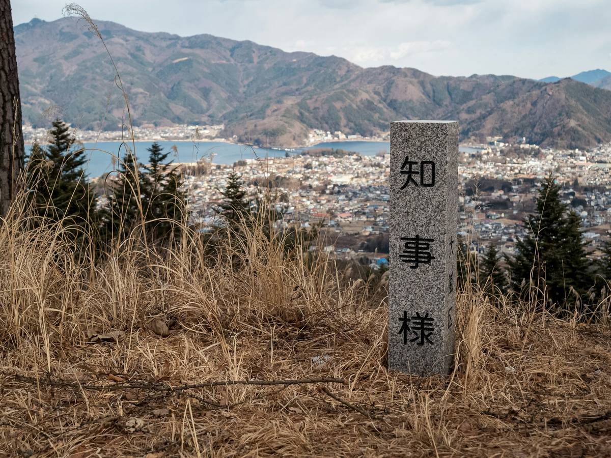 Close-up of a watch showing incorrect altitude reading next to a rugged mountain landscape.