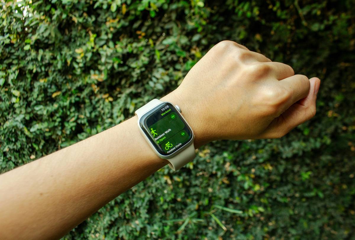 Portrait of a mountaineer using a high-tech watch altimeter