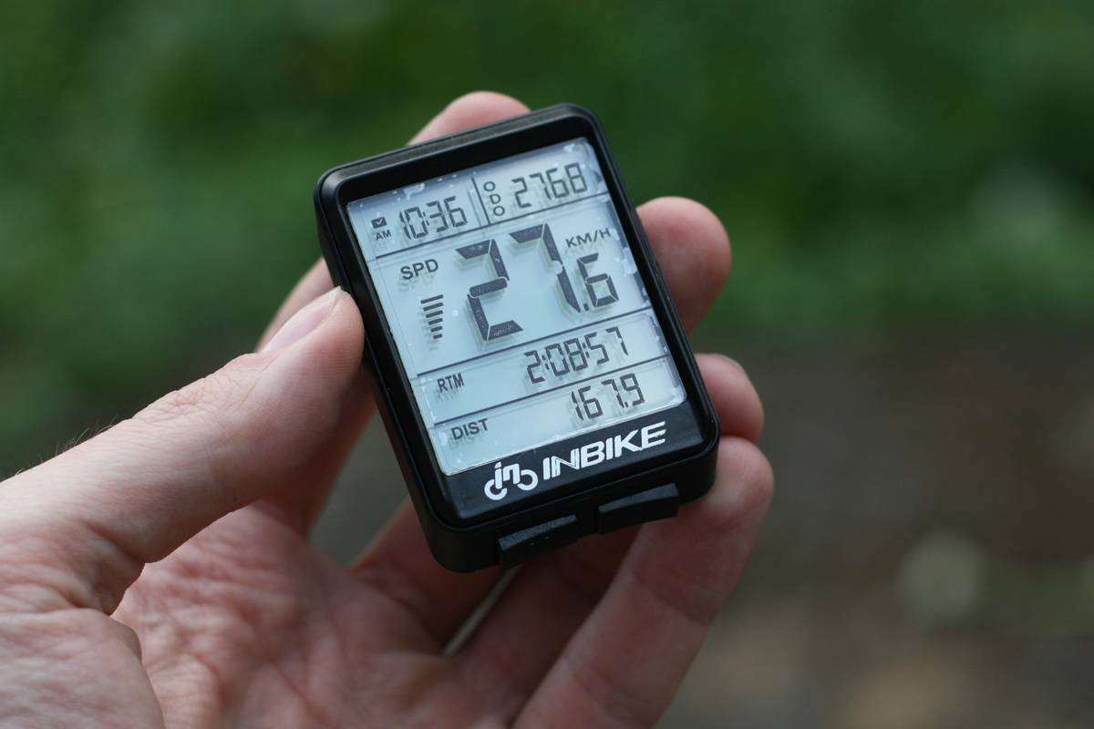 Alex standing atop Mount Elbert wearing their altimeter watch
