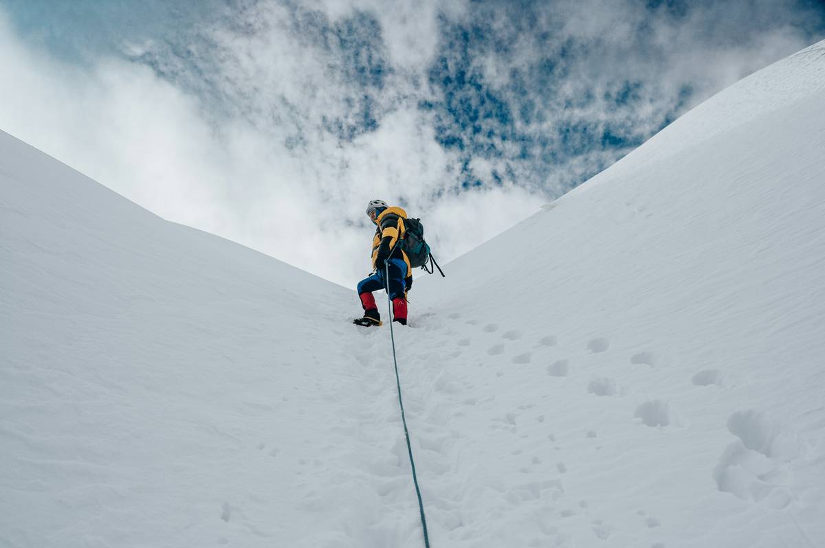 A climber checking their watch at high altitude