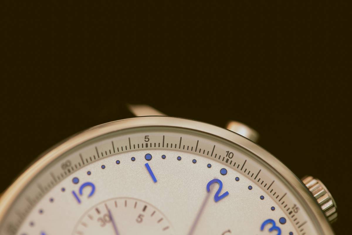 Person wearing an altimeter watch while navigating foggy conditions outdoors