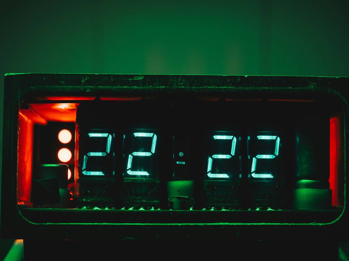 A rugged smartwatch displaying altitude information against a mountain background